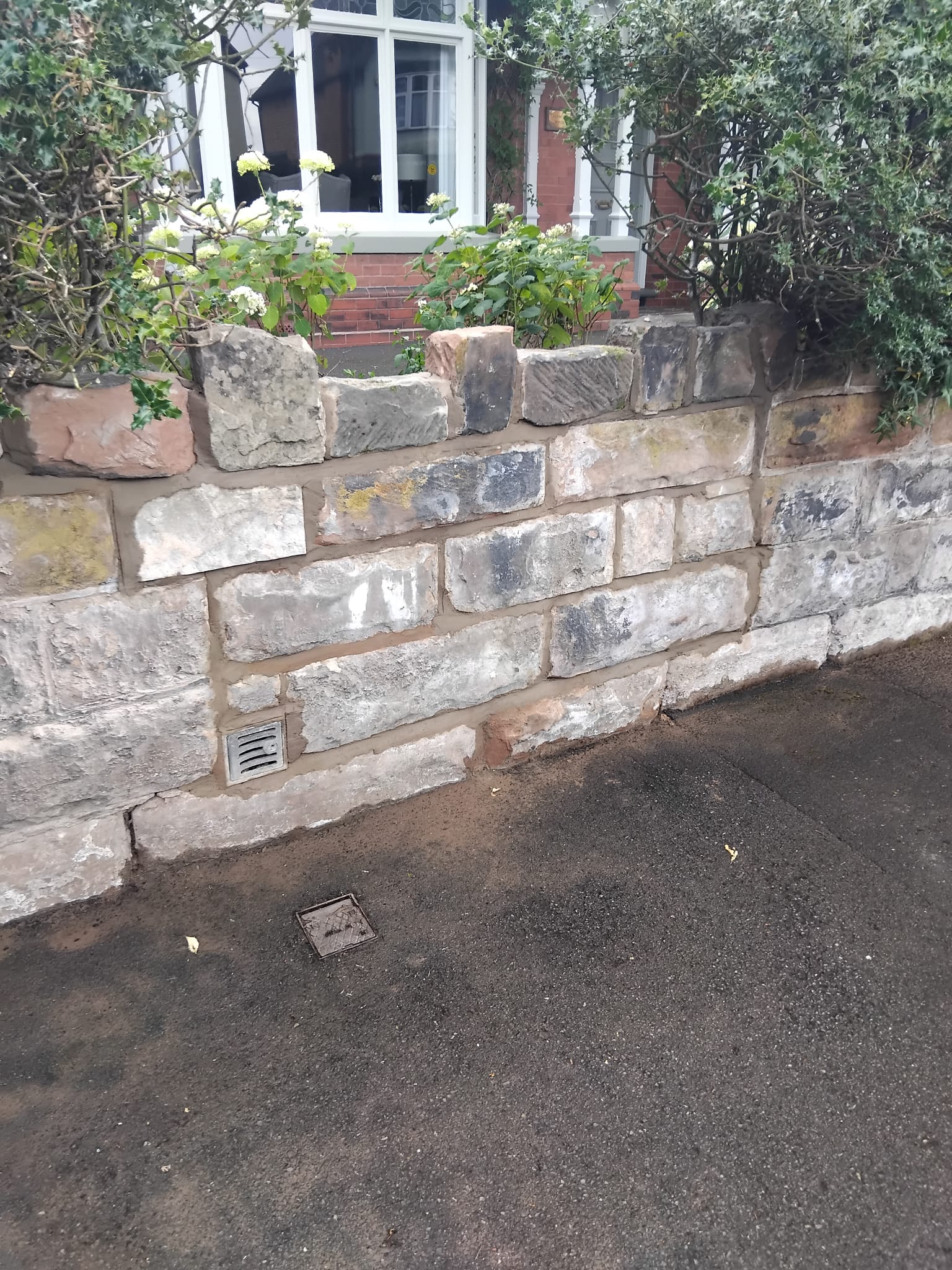 Stone-faced garden wall and existing planting