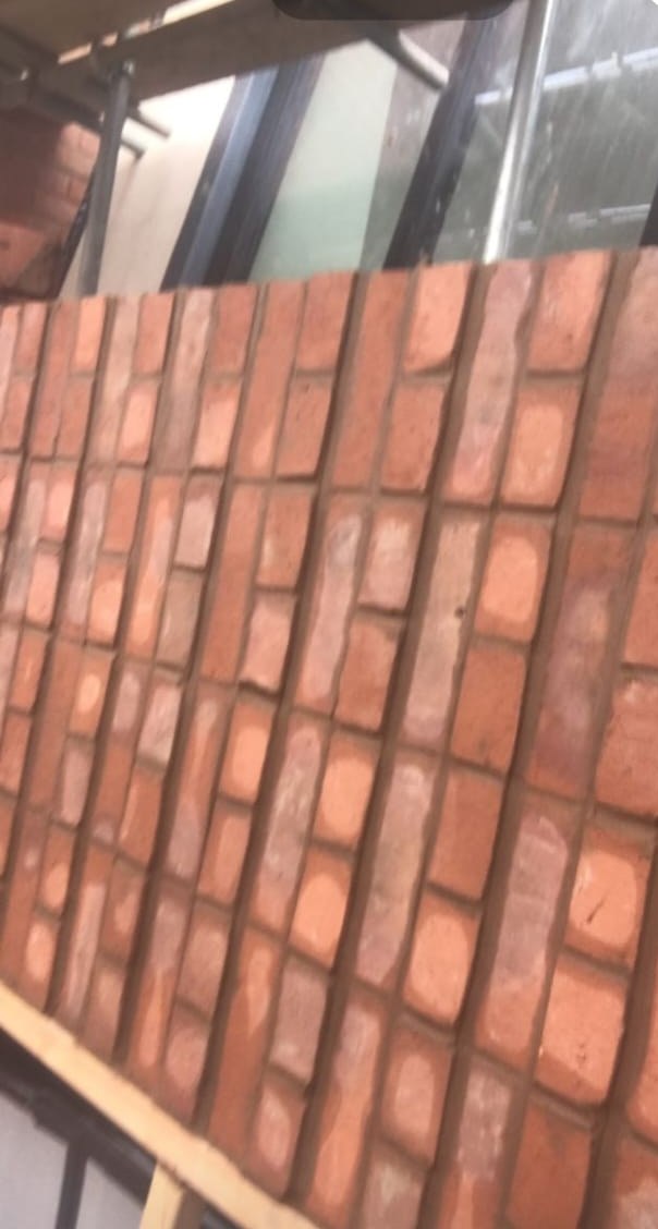 Angled red brick wall