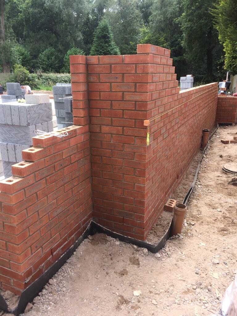 Red brick pier and wall with block work behind