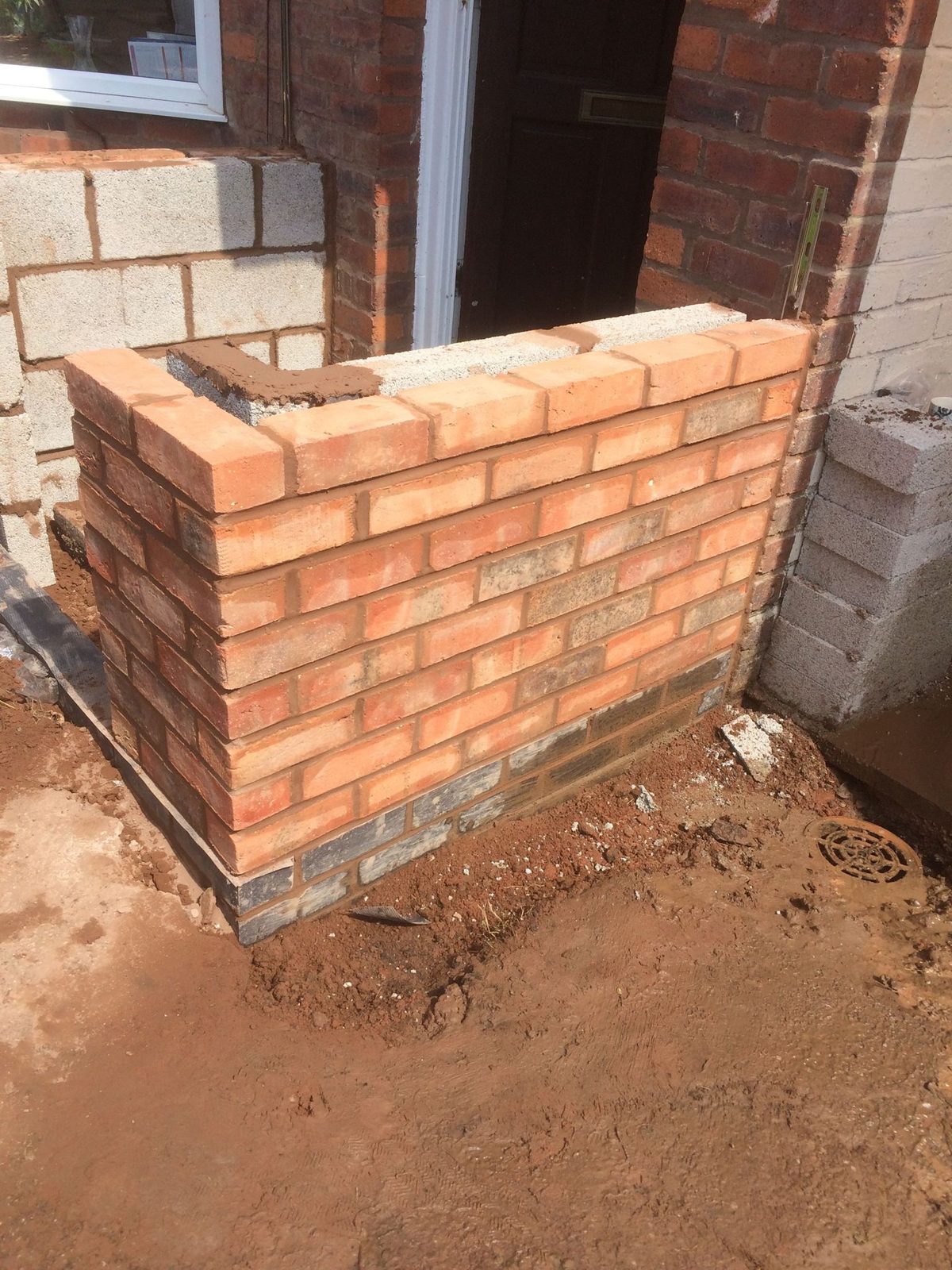 Red brick pier under construction on a new build plot