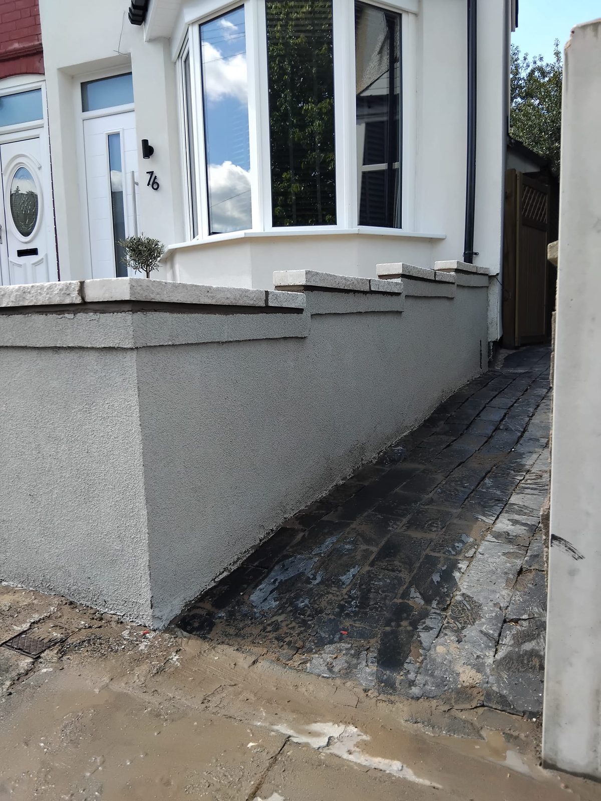 Brick frontage with new paving and a bay window