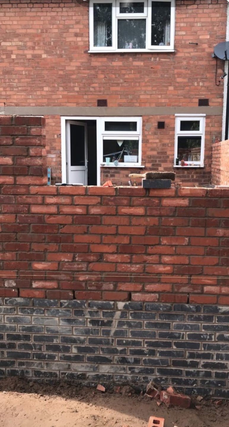 Red brick garden wall built by C.M Brickwork up to existing house